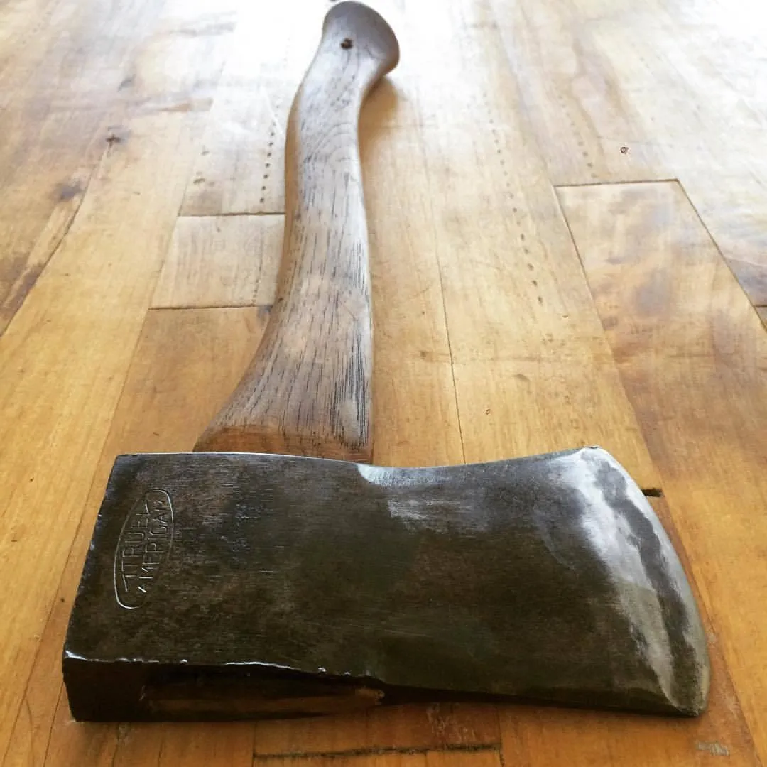 Axe resting on a wooden plank floor