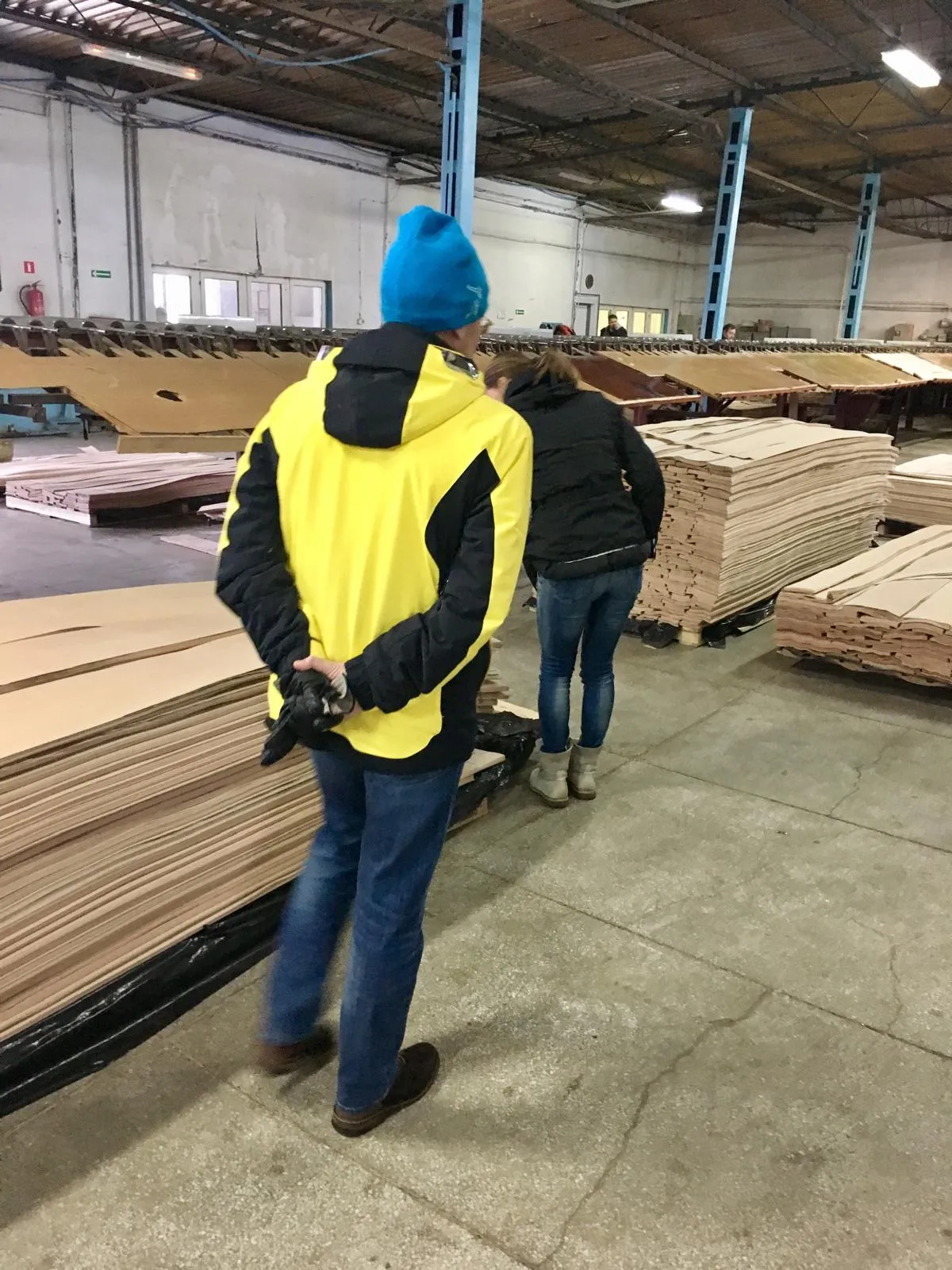 Visitors looking at veneer stock in a warehouse